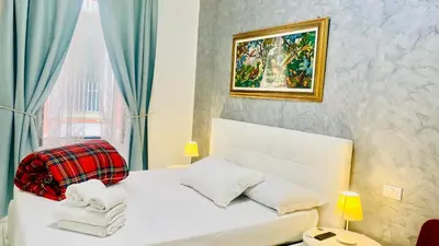 a bedroom with a white bed with blue curtains at I Dormienti in Rome