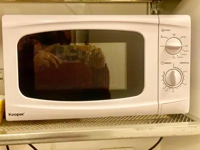 a white microwave oven sitting on a shelf at I Dormienti in Rome