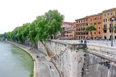 a view of a river with people walking on the street at Casa Sangallo in Rome