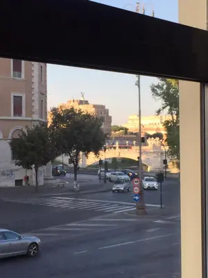 a window view of a city street with cars parked at Casa Sangallo in Rome