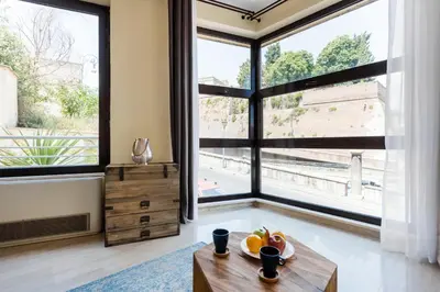 a living room with a table and a large window at Casa Sangallo in Rome