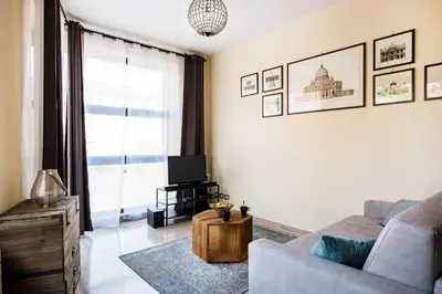 a living room with a couch and a tv at Casa Sangallo in Rome