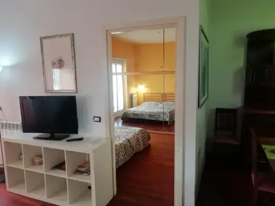 a room with a television and a bedroom with a bed at Casa di Marco a Trastevere in Rome
