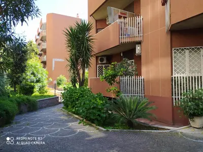 a building with a balcony and plants in front of it at Casa di Marco a Trastevere in Rome