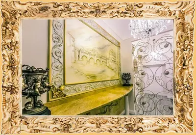 a mirror with a gold frame in a room at Impero Vaticano Suites Guest House in Rome