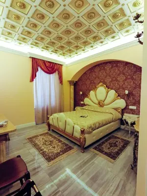 a bedroom with a large bed with a flower headboard at Impero Vaticano Suites Guest House in Rome