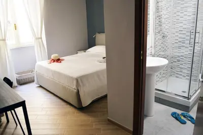 a small bedroom with a bed and a sink at Colosshouse guest house in Rome