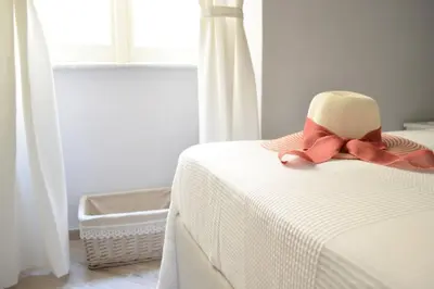 a bed with a hat and a bow on it at Colosshouse guest house in Rome