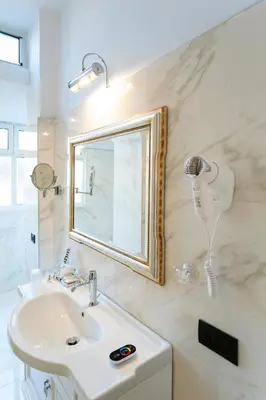 a bathroom with a sink and a mirror at Royal House in Rome