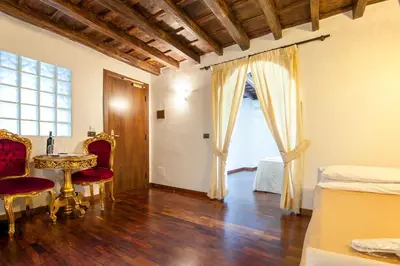 a room with a table and chairs and a window at Royal House in Rome