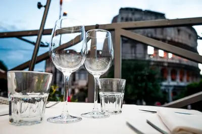 three wine glasses sitting on top of a table at Royal House in Rome