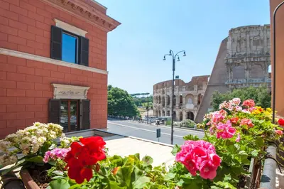 a balcony with flowers in front of a building at Royal House in Rome