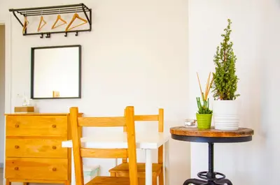 a room with a table and a chair and a mirror at By Grace in Rome