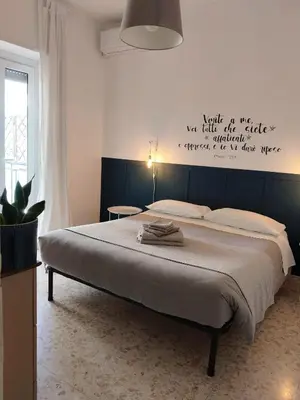 a bedroom with a bed with a sign on the wall at By Grace in Rome