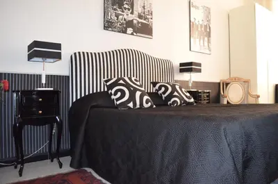 a bedroom with a bed with black and white pillows at Sweetdreams Inn in Rome