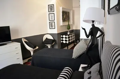 a bedroom with a bed and a lamp and a chair at Sweetdreams Inn in Rome