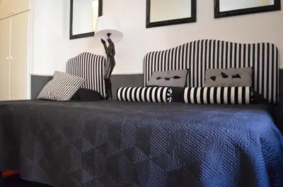 a bedroom with a bed with a blue blanket and two chairs at Sweetdreams Inn in Rome