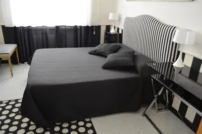 a black bed with pillows on it in a room at Sweetdreams Inn in Rome
