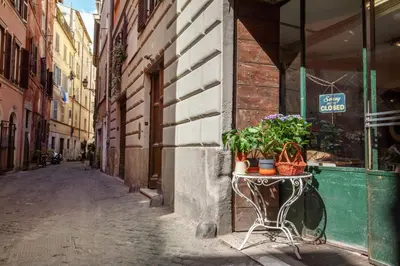 an empty alley with a table with plants on it at The right place 4U Grotte Apartment in Rome