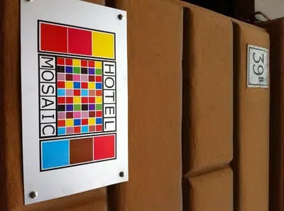 a sign on a door with colorful squares on it at Hotel Mosaic in Rome