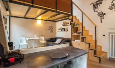 a kitchen and living room with a spiral staircase at Terrace99 in Rome
