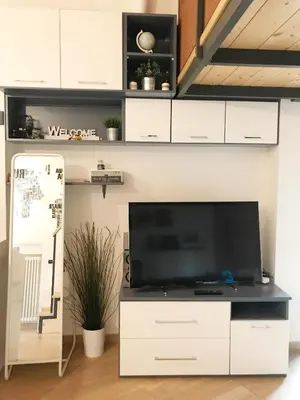 a living room with a tv on a white cabinet at Terrace99 in Rome