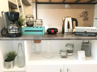 a kitchen shelf with a coffee maker and glasses at Terrace99 in Rome