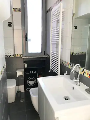 a bathroom with a white sink and a toilet at Terrace99 in Rome