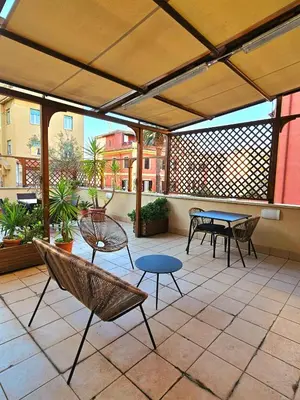a patio with tables and chairs on a patio at Terrace99 in Rome