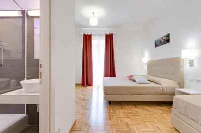 a bedroom with a bed and a tub and a sink at Dolce Luxury Rooms in Rome