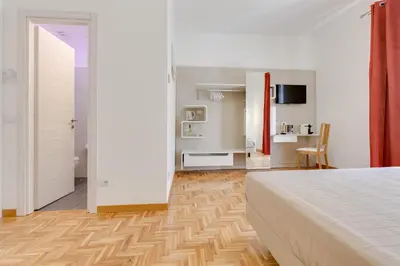 a bedroom with a bed and a living room at Dolce Luxury Rooms in Rome
