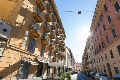 a building with balconies on a city street at Dolce Luxury Rooms in Rome