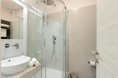 a bathroom with a sink and a shower at Dolce Luxury Rooms in Rome