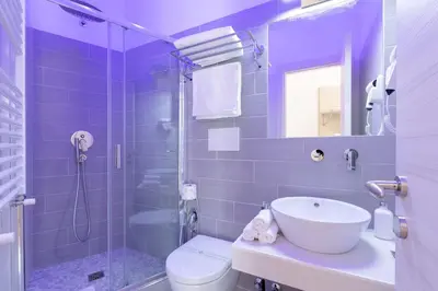 a bathroom with a sink and a toilet and a shower at Dolce Luxury Rooms in Rome