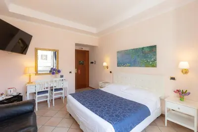 a hotel room with a bed and a tv at Rome To Stay in Rome
