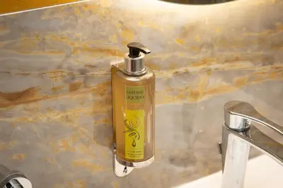 a bottle of liquid soap sitting on a sink at Rome To Stay in Rome