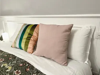 a white bed with two pillows on it at Monti49 GuestHouse in Rome
