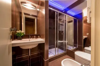 a bathroom with a shower and a sink and a toilet at St. Peter Guest House in Rome