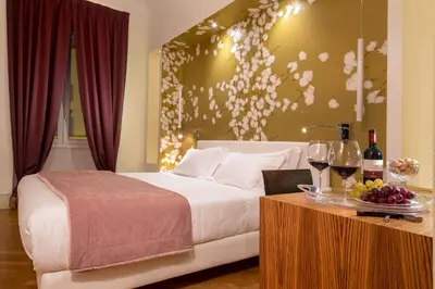 a hotel room with a bed and a table with wine glasses at St. Peter Guest House in Rome
