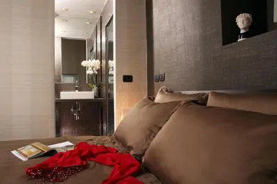 a bedroom with a bed with a red dress on it at St. Peter Guest House in Rome
