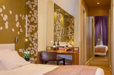 a hotel room with a bed and a desk with a table at St. Peter Guest House in Rome