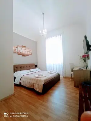 a bedroom with a bed and a large window at El Dorado Vatican in Rome