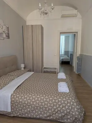 a bedroom with a large bed with two towels on it at El Dorado Vatican in Rome