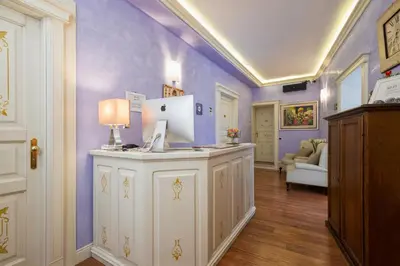 a room with purple walls and a desk with a computer on it at Navona Tower Relais in Rome
