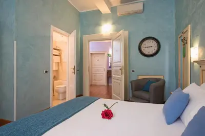 a bedroom with a bed and a clock on the wall at Navona Tower Relais in Rome
