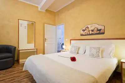 a bedroom with a bed with a flower on it at Navona Tower Relais in Rome