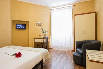 a hotel room with a bed and a chair at Navona Tower Relais in Rome