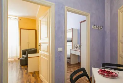 a living room with a table and a room with a chair at Navona Tower Relais in Rome