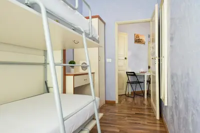 a small room with bunk beds and a desk at Navona Tower Relais in Rome