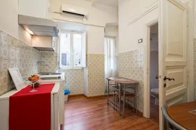a kitchen with a red counter top in a room at Navona Tower Relais in Rome